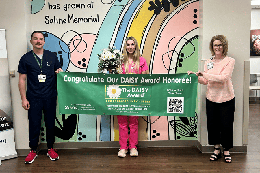 Chief Nursing Officer Josh Orzel stands with DAISY Award honoree Kestynn Terry and Quality Director Amy Sullins after Terry was recognized for her extraordinary patient care.