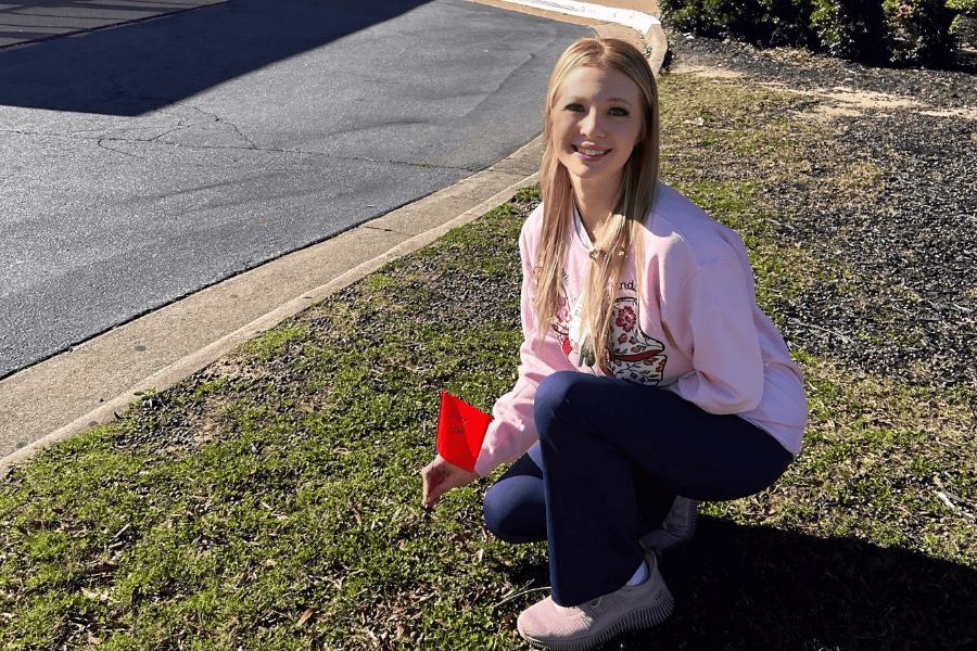 Chelsea demonstrates planting a flag in honor of her family member, Emory.