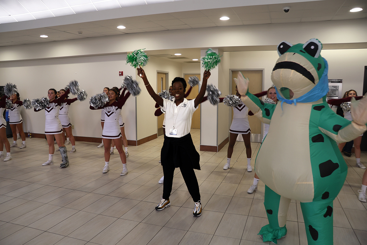 Saline Health System CEO Char Boulch joins the Benton High School cheerleaders and the hospital’s safety frog mascot during an employee pep rally celebrating Saline Memorial Hospital’s Leapfrog Grade A.