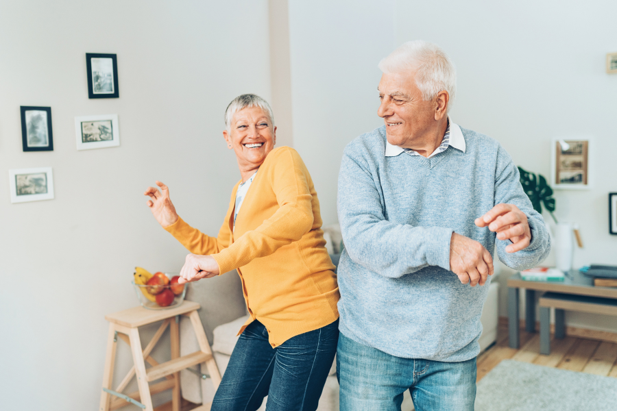 Older couple dancing in living room